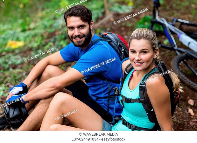 Athletic couple relaxing in forest