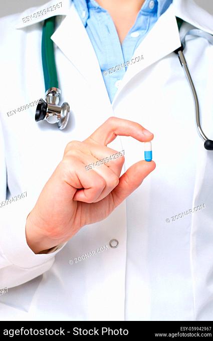 Female doctor showing a blue pill