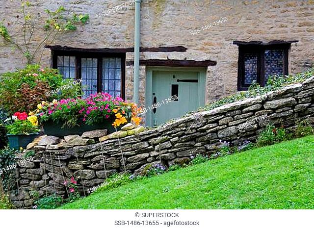 Stone cottage on Arlington Row, Bibury Village, Gloucestershire, Cotswold District, England, United Kingdom, Europe