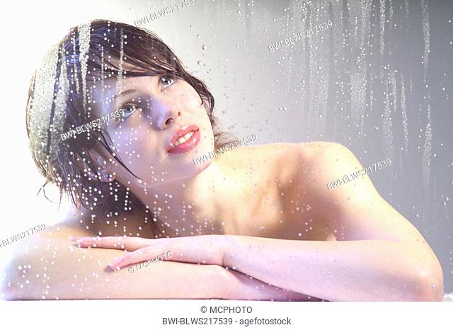 Woman behind wet glass