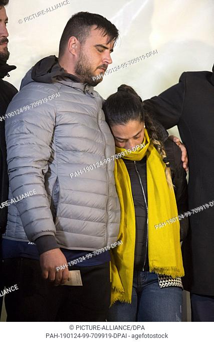 24 January 2019, Spain, Totalan: Jose Rosello (l) and Vicky Garcia (M.), parents of the two-year-old Julen, close their eyes and hug each other at a meeting...