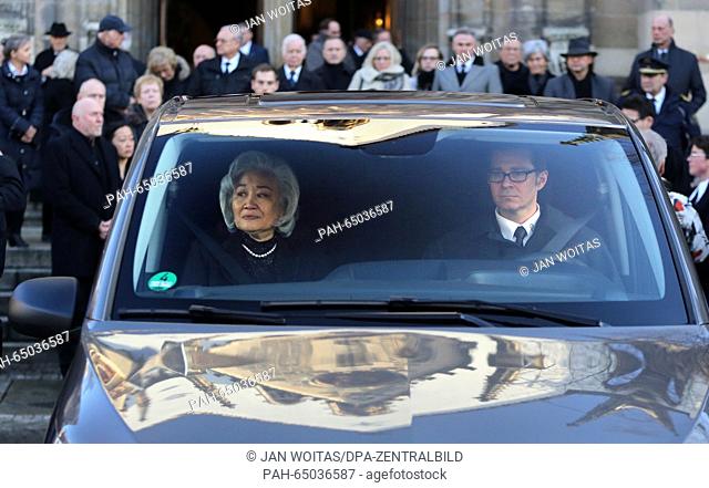The widow of conductor Kurt Masur, Tomoko Sakurai-Masur sits in a funeral van in front of the St. Thomas Church after funeral services in Leipzig, Germany