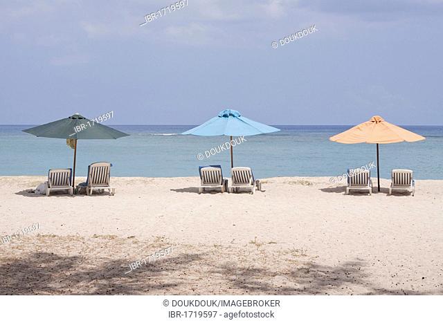 Sunloungers and beach umbrellas on the public beach of Flic en Flac, Mauritius, Africa