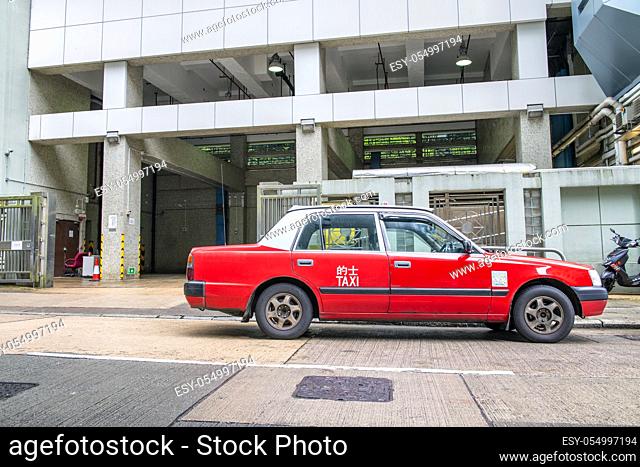 HONG KONG - MAY 2014: Famous red city taxi parked along the road