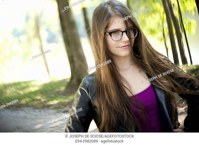 A casual portrait of a 26 year old woman with long brown hair and big  glasses, on a country road, Stock Photo, Picture And Rights Managed Image.  Pic. E94-2982089 | agefotostock