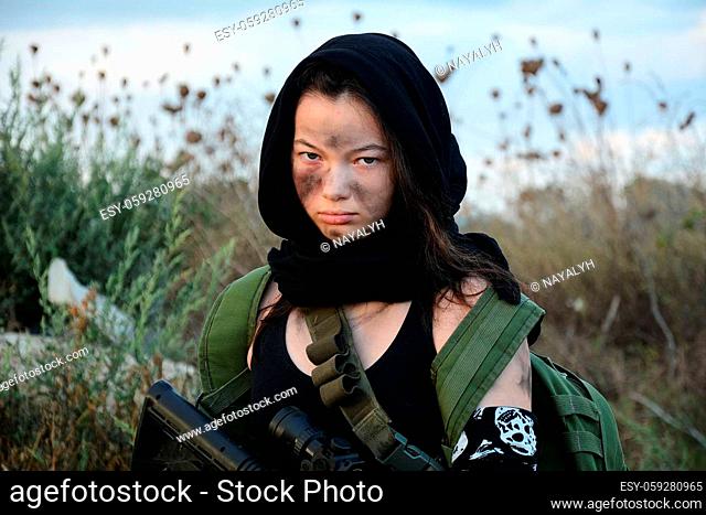 A female militia soldier in a post apocalyptic desert wasteland. Urban combat and wasteland