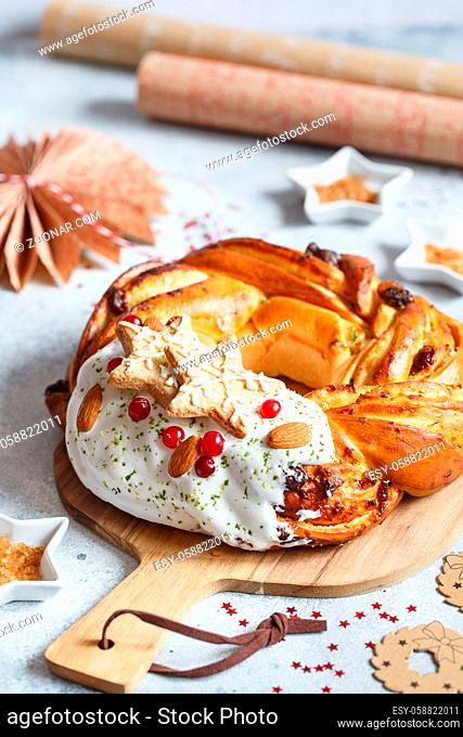 Sweet Bread Wreath decorated with stars cookies. Honey brioche garland with dried berries and nuts. Holiday recipes. Braided Bread