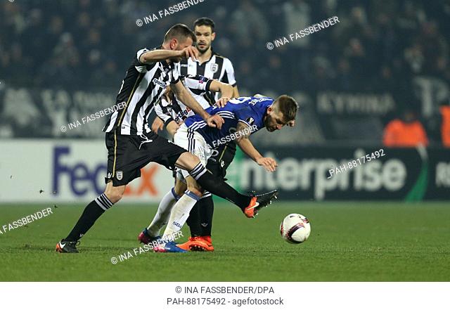 Schalke's Guido Burgstaller and PAOK's Stelios Malezas (L) and Evgen Shakhov (C) vie for the ball in the first leg of the Europa League round of 32 knock-out...