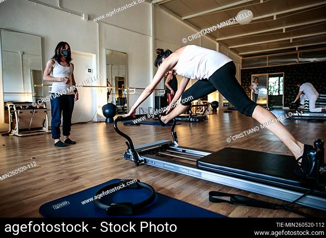 People during a pilates reformer class in a gym reopened after the lockdown due Covid-19 emergency , Rome, ITALY-26-05-2020