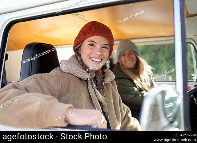 Portrait happy young women friends inside camper van