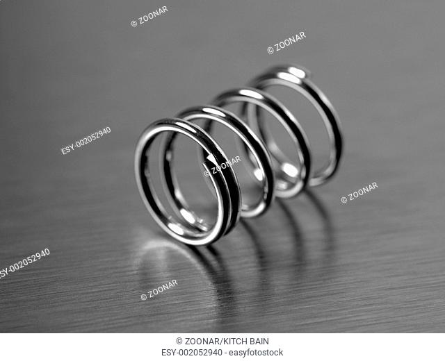 A spring isolated against a silver background