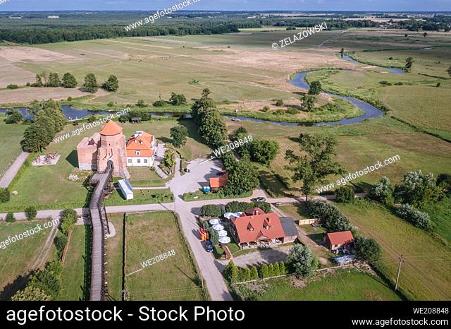 Drone view of Gothic ducal castle from 15th century on the bank of Liwiec River in Liw village, Masovian Voivodeship of Poland