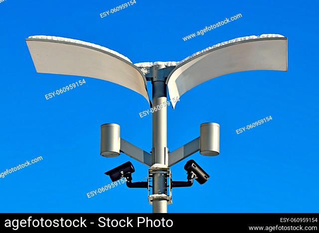 Surveillance cameras and modern lighting fixtures on the lamppost