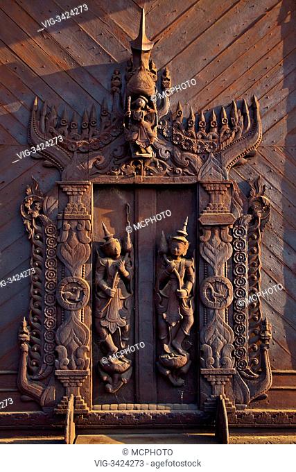 An elaboratly carved door at the SHWE IN BIN KYAUNG known as the TEAK MONASTERY and built in 1895 - MANDALAY, MYANMAR - 10/05/2012