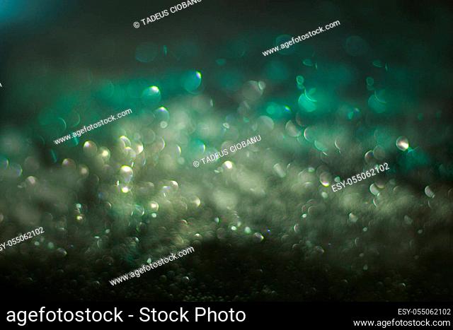 Abstract compositione in green bokeh on black background