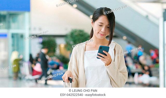 Woman use of mobile phone in the airport