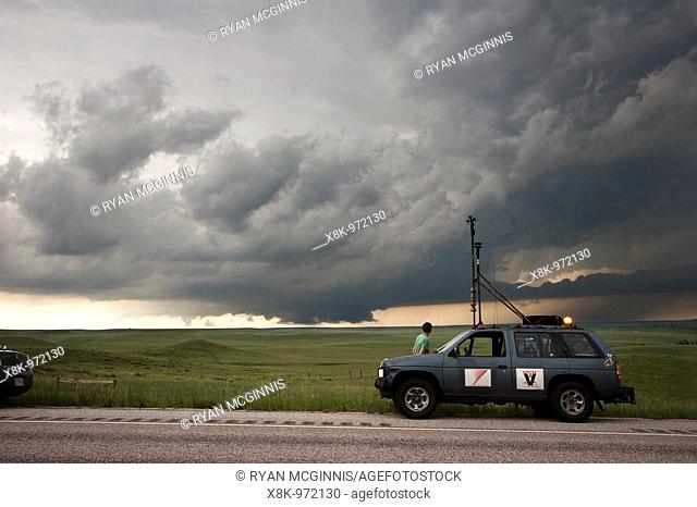 Storm chasers with Project Vortex 2 watch a distant wall cloud and supercell in Goshen County, Wyoming, June 5, 2009  Project Vortex 2 is a two year National...