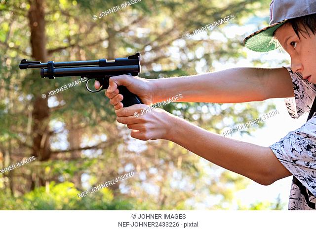 Boy aiming gun
