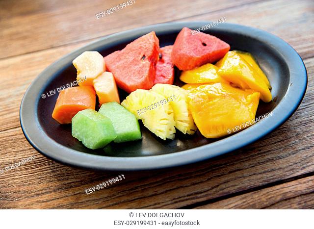 food, eco, bio and summer holidays concept - still life with exotic tropical fruits in bowl