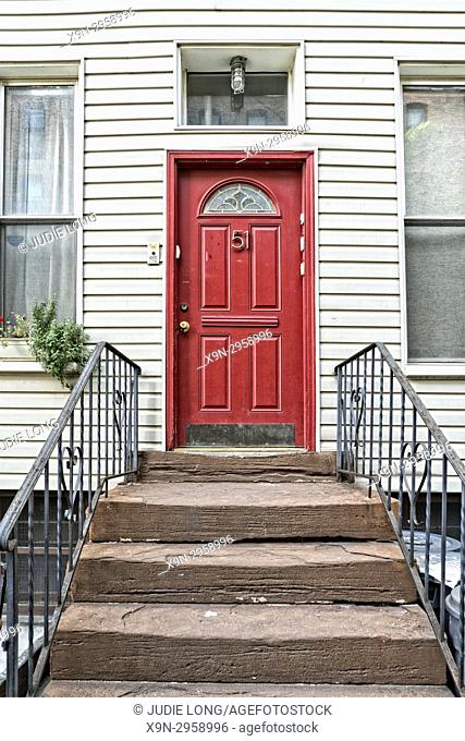 Brooklyn, NY, Greenpoint. Close-up of a Red Entry Door on a Typical Wooden Home