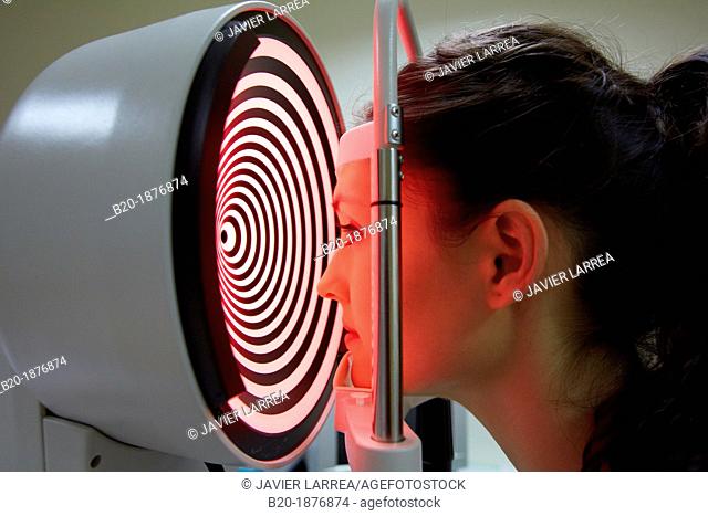 Eye examination  Patient having a corneal topography measurement made of her eye  The device at centre projects bright rings onto the eye