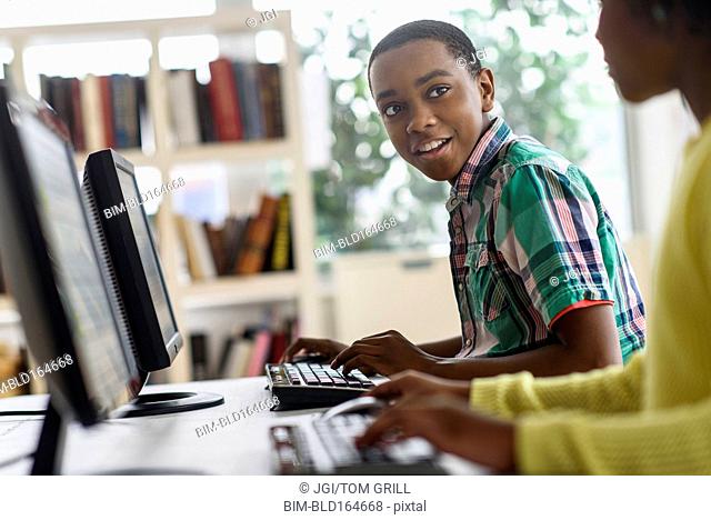 Black students using computers in classroom