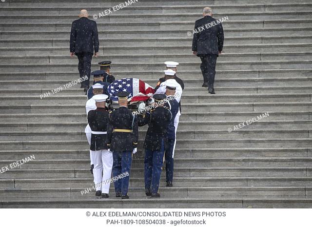 A United States Military Honor Guard carries the casket of former Senator John McCain, Republican of Arizona, up the stairs of the Capitol in Washington