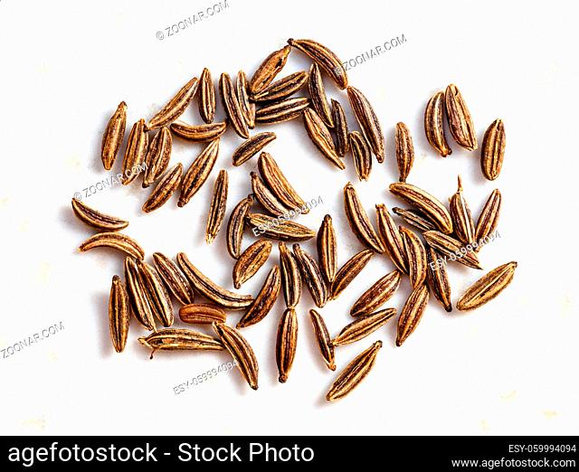 several caraway seeds close up on gray ceramic plate