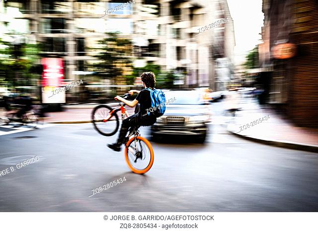 American boys doing stunts on the bicycle in the streets of Boston