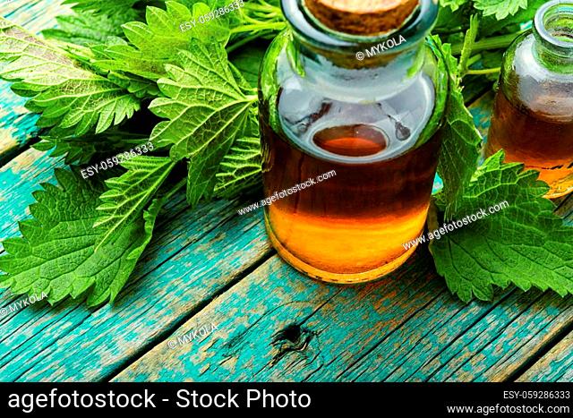 Nettle essence in glass bottle.Healing herbs.Stinging nettles in herbal medicine