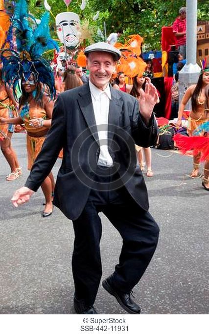 UK, England, London, Eccentric Englishman dancing in street during Carnival Del Pueblo, Carnaval Del Pueblo Festival is Europes Largest Latin Street Festival