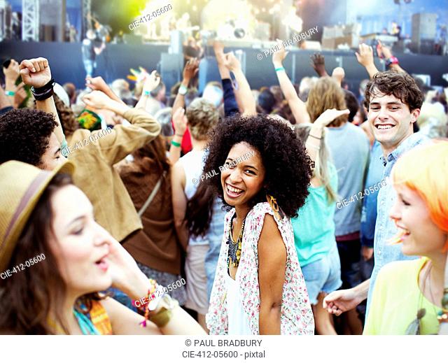 Fans dancing and cheering at music festival