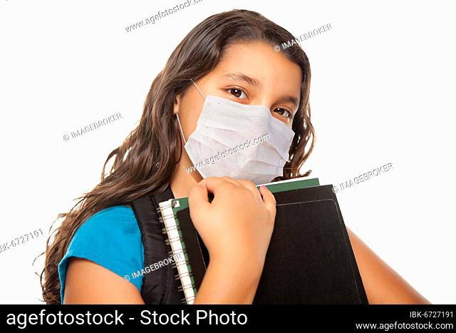 Hispanic student girl wearing face mask with books isolated on white