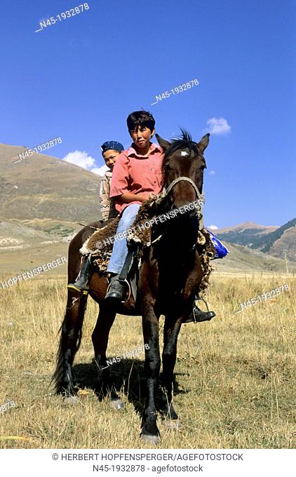 Kyrgyz Rider; Mountains; Local People; guarded the Horses, small and big Boy on here own hors; Kyrgyzstan