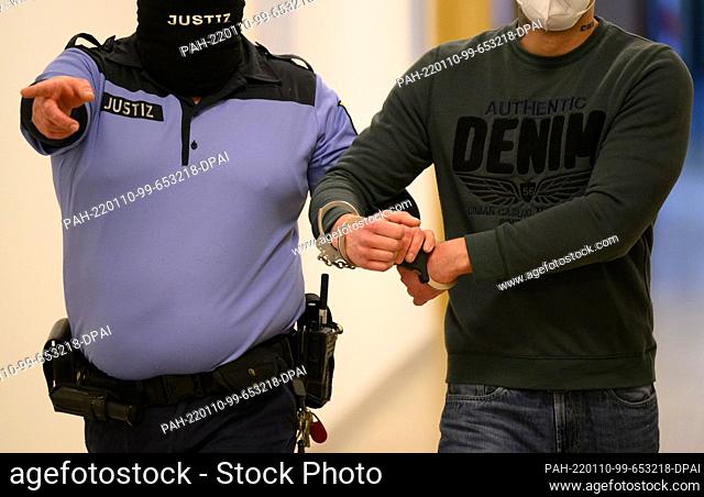 10 January 2022, Saxony, Dresden: A defendant is led into the courtroom at the local court before the start of the trial following the riots on May 16, 2021