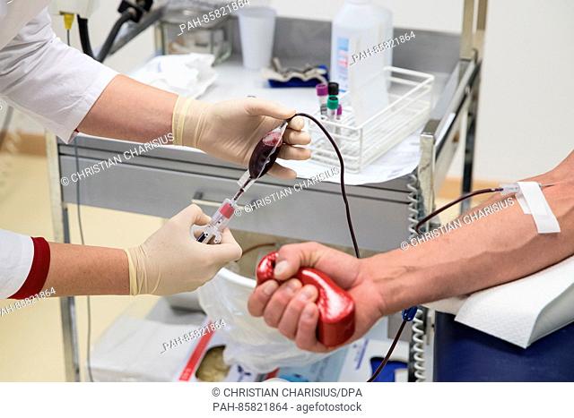 An employee takes blood from a blood donor at the DRK North East blood donation service in Luetjensee near Hamburg,  Germany, 17 November 2016
