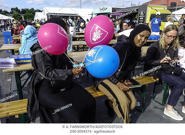 Arab girls with balloons attend the political rally called Jarvaveckan in the immigrant Tensta-Rinkeby suburb. Stockholm, Sweden