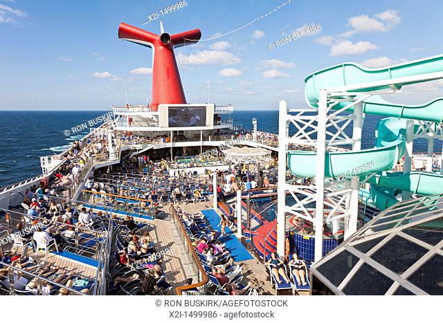 Cruise passengers watching NFL football game on deck of Carnival's Triumph cruise ship in the Gulf of Mexico