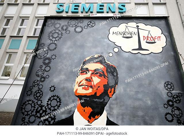 A protest siugn with the picture of Siemens head Joe Kaeser pictured in front of Siemens' turbo engines factory in Leipzig, Germany, 13 November 2017