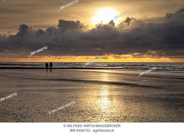 Walkers at coast, evening light, sunset with clouds, Norderney, East Frisian Island, East Frisia, Lower Saxony, Germany