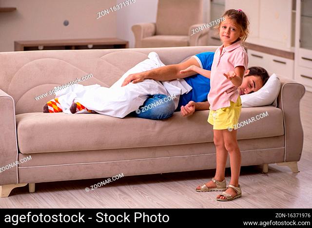 Young man with his small daughter at home