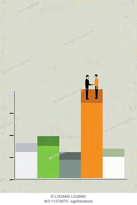 Businessmen shaking hands on top of bar graph