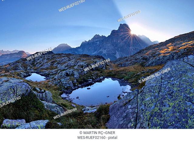 Italy, Dolomites, Pale di San Martino Mountain group with mountain peak Cimon della Pala and two small mountain lakes at sunrise