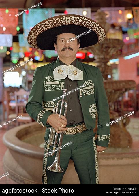 Hispanic mariachi musician holding trumpet
