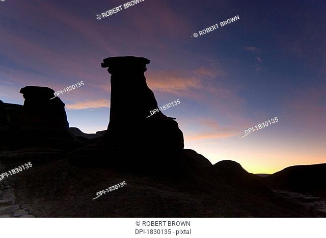 Sunrise over hoodoo rock formations, Drumheller, Alberta, Canada
