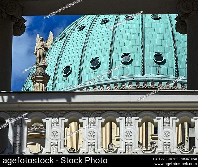 28 June 2022, Brandenburg, Potsdam: A view through the Fortuna Portal at the Landtag shows the dome of St. Nicholas Church on the Alter Markt with a statue of...