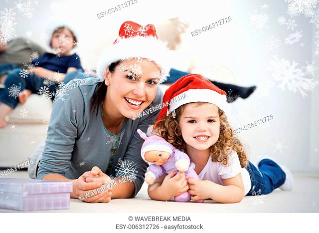Happy mother and daughter at christmas lying on the floor