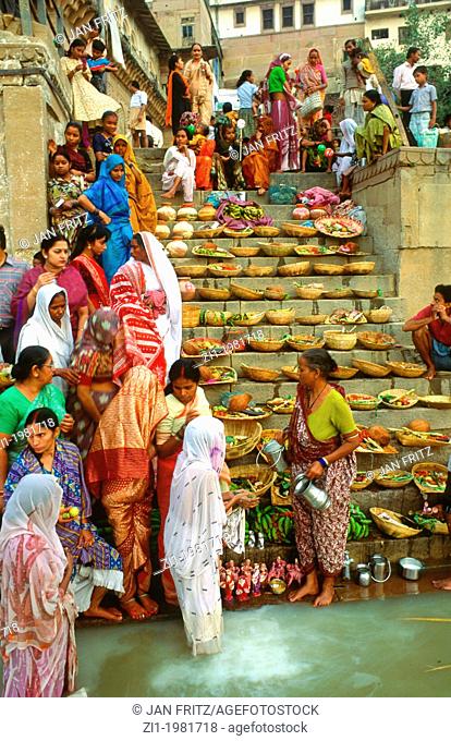 women ritual were fruit is offered to the Gods in the Ganges in Varanasi, India
