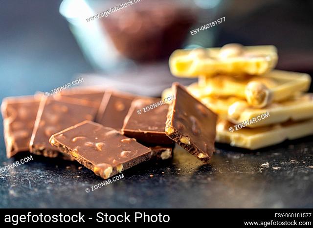 Chocolate bar with nuts on black table