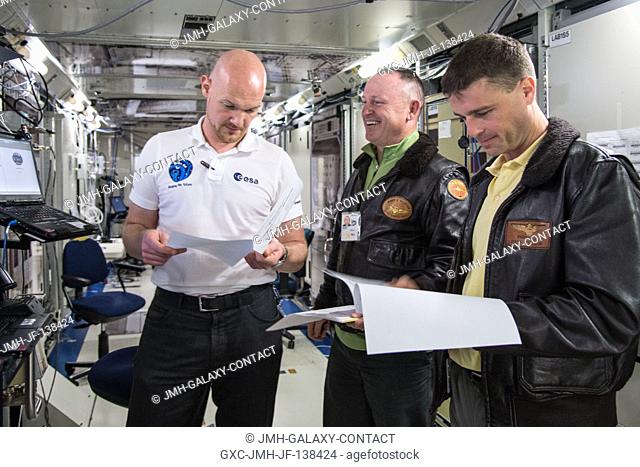 NASA astronaut Barry Wilmore (center), Expedition 41 flight engineer and Expedition 42 commander; and European Space Agency astronaut Alexander Gerst (left) and...